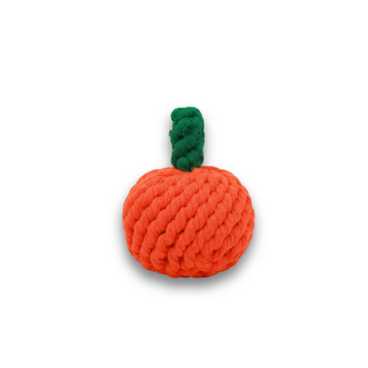 Handmade orange rope dog toy with a green handle.