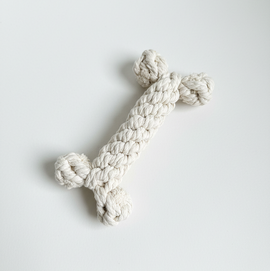 White knotted rope toy on a light gray background
