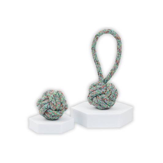 Multicolored knotted rope ball toy on a white background