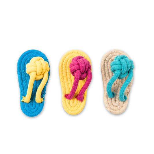 Three colorful dog toys shaped like flip-flops with knotted ends on a white background