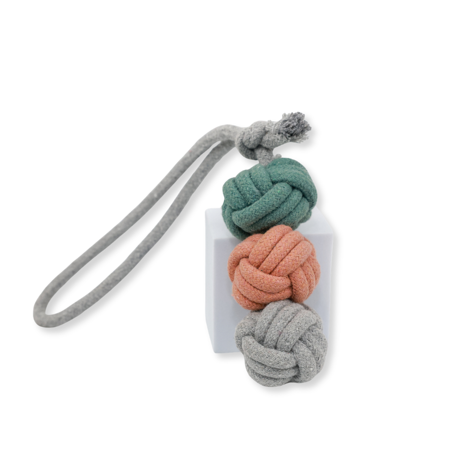 Knot-shaped keychain with gray, green, and pink colors on a white background