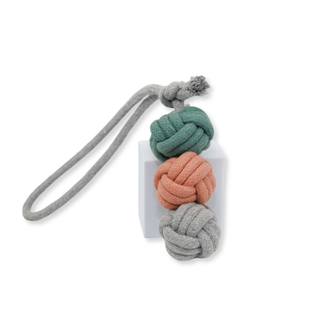 Knot-shaped keychain with gray, green, and pink colors on a white background