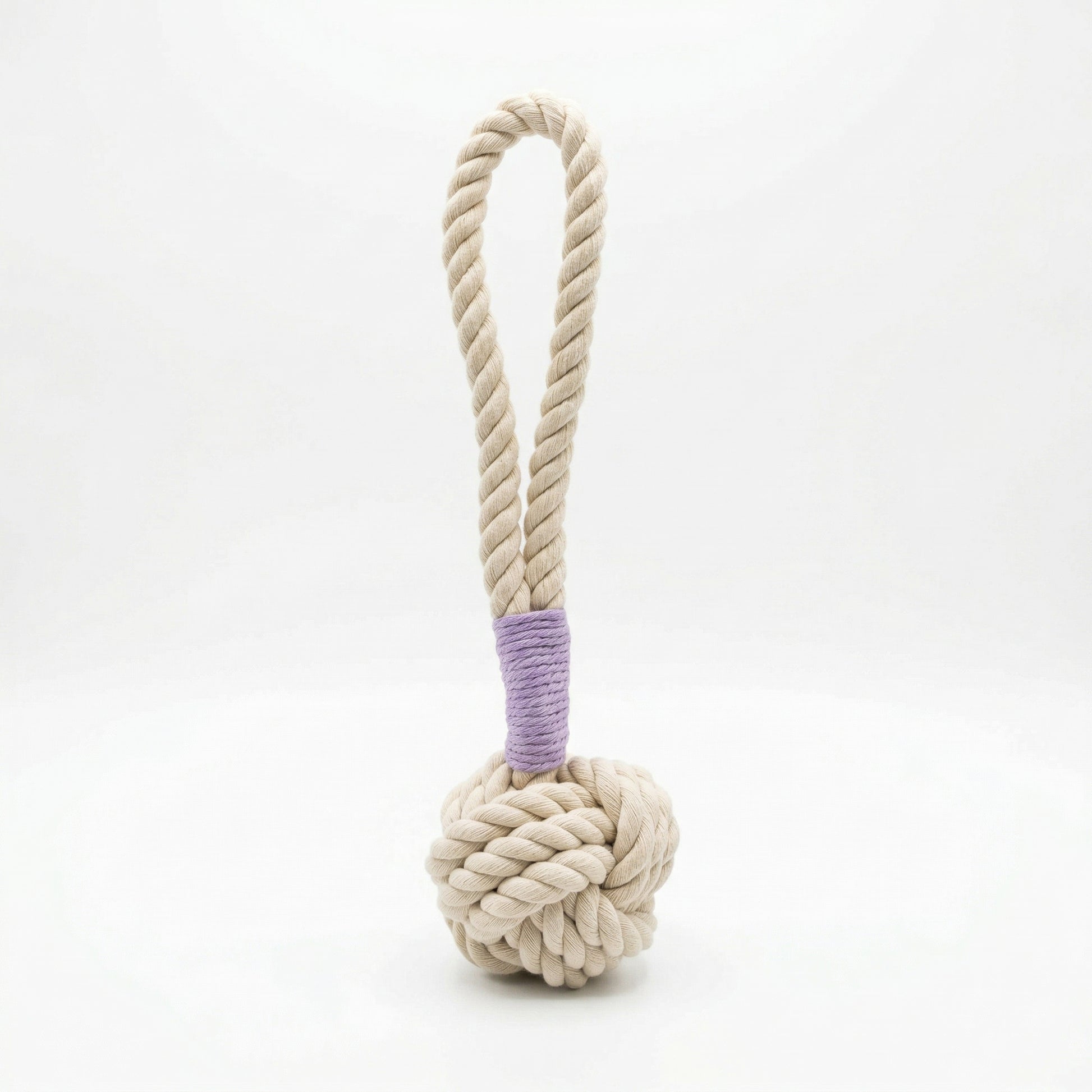 Dog toy with a knotted rope ball and handle on a white background