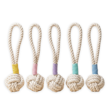 Five rope toys with knotted ends and colorful bands on a white background