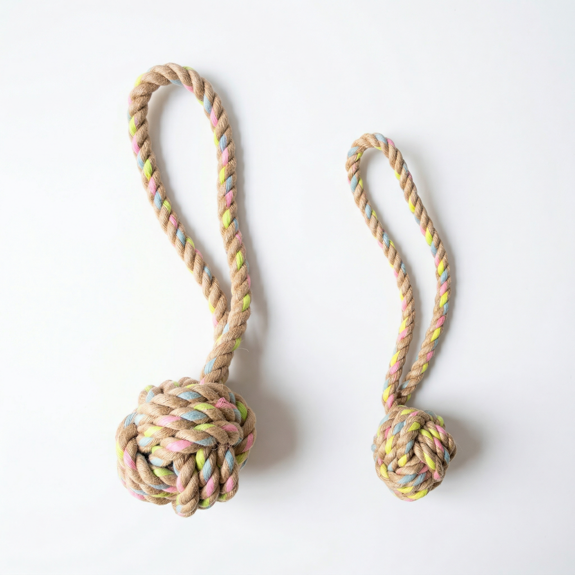 Two rope toys with colorful knot ends on a white background