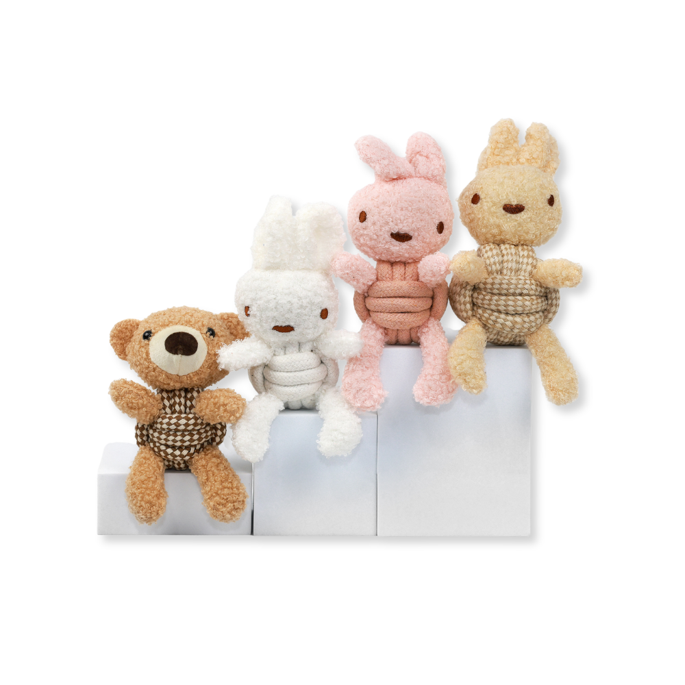 Four plush toys, including a bear, rabbit, and others, on a white background.