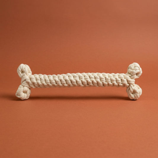 Dog toy made of braided rope on a brown background
