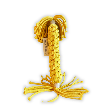 Yellow braided dog toy with a brand tag on a white background
